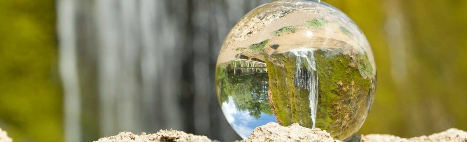 Photo by Marc Schulte clear glass ball on brown rock